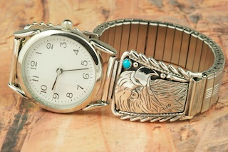 Genuine Sleeping Beauty Turquoise set in Sterling Silver Watch Tips. Sterling Silver Eagle Design. Mens Watch with expandable band. Created by Navajo Artist Thomas Chischilly. Signed.